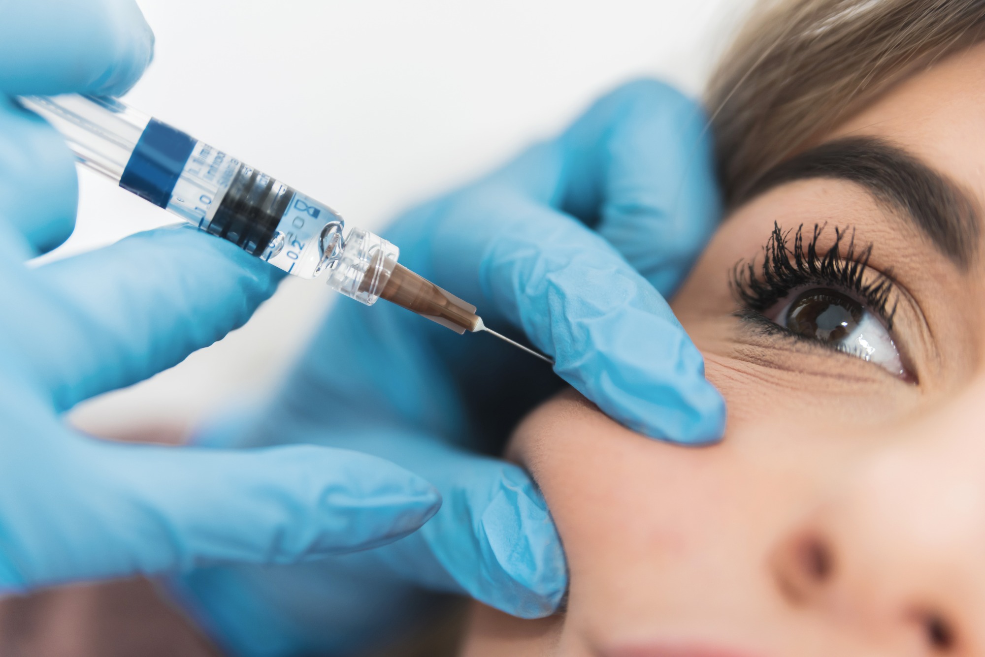 Receiving Botox in an aesthetic clinic Receiving Botox in an aesthetic clinic