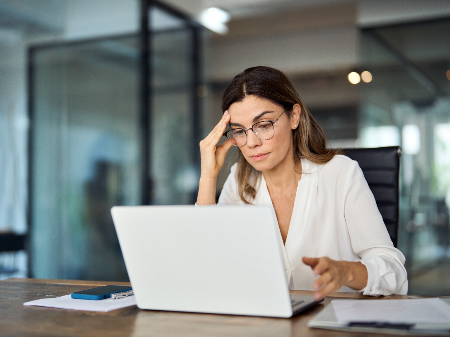 woman with migraine, wearing glasses