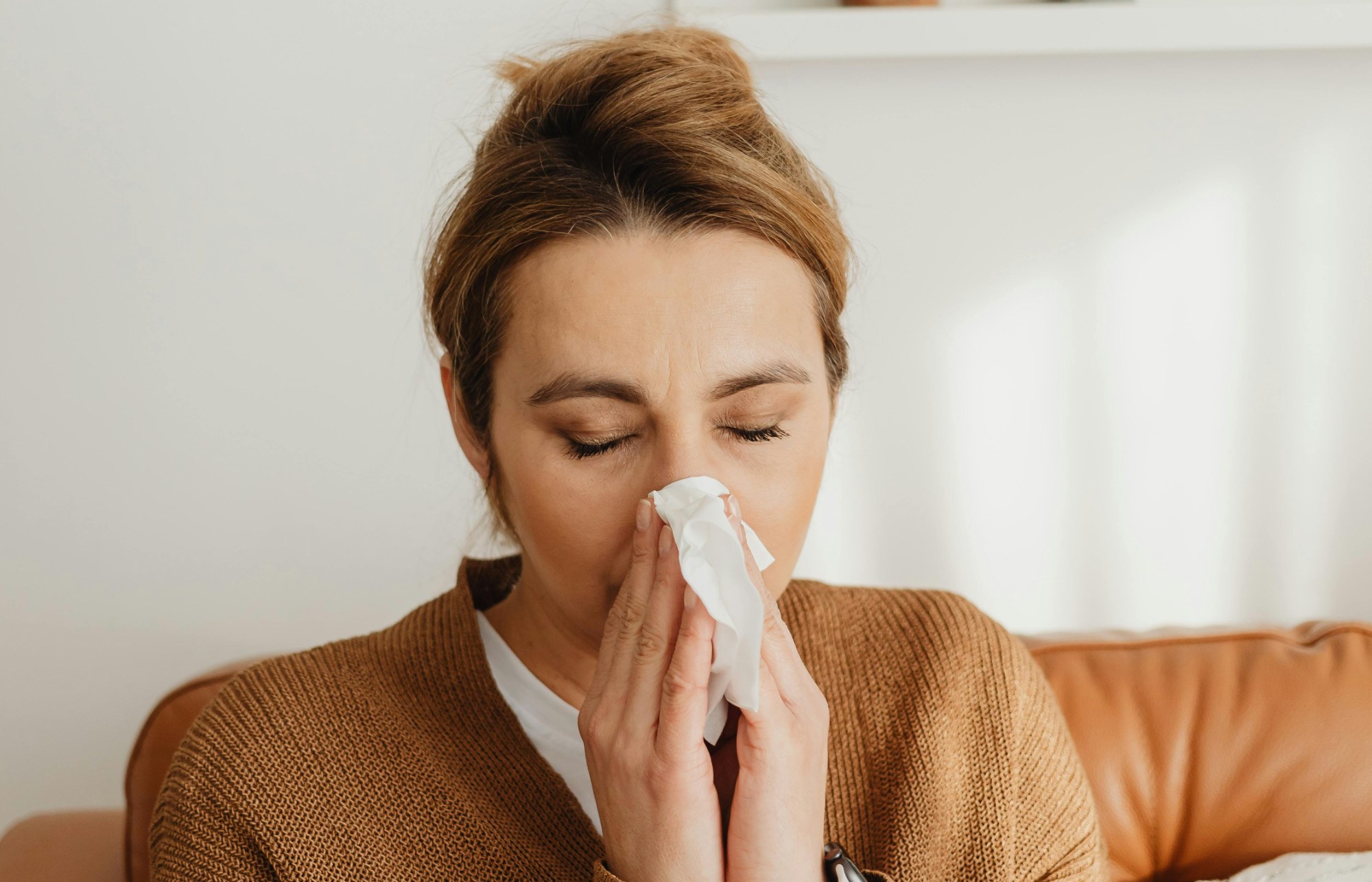 Woman blowing nose