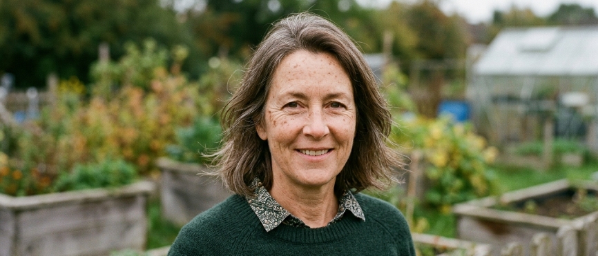 Mature woman with sun-exposed, freckled skin outdoors.
