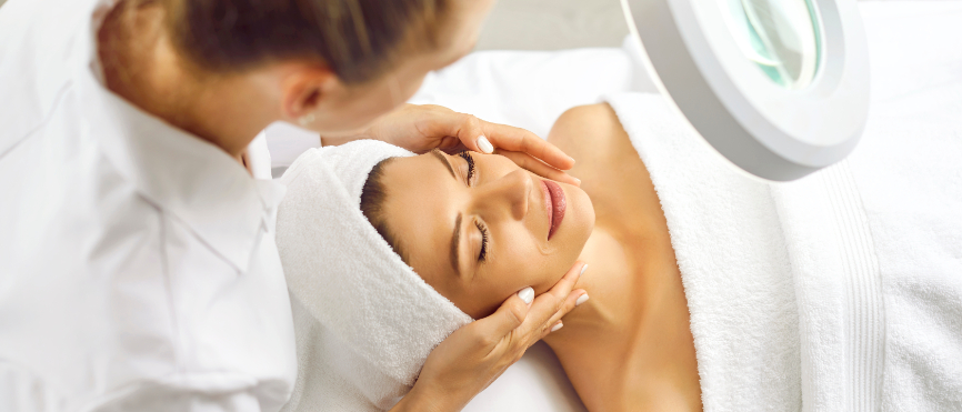 Young professional woman cosmetologist examining skin condition.